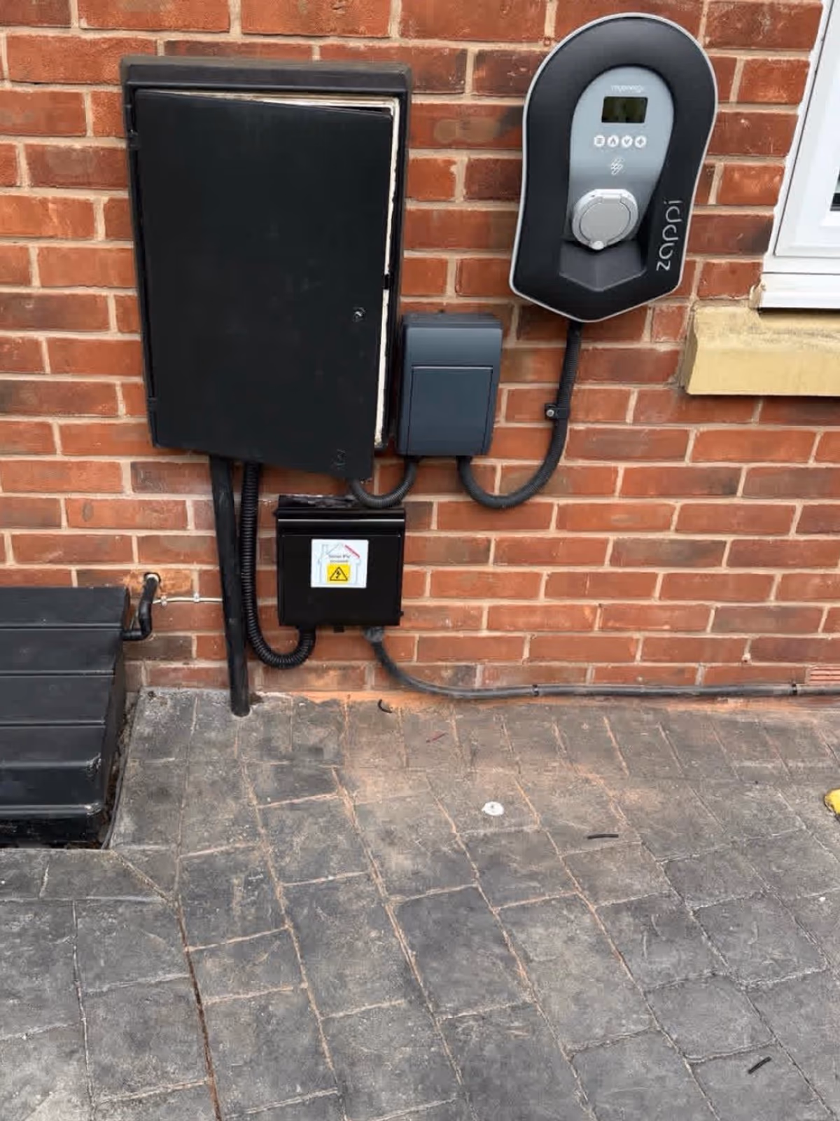 Zappi EV charger on an outdoor wall