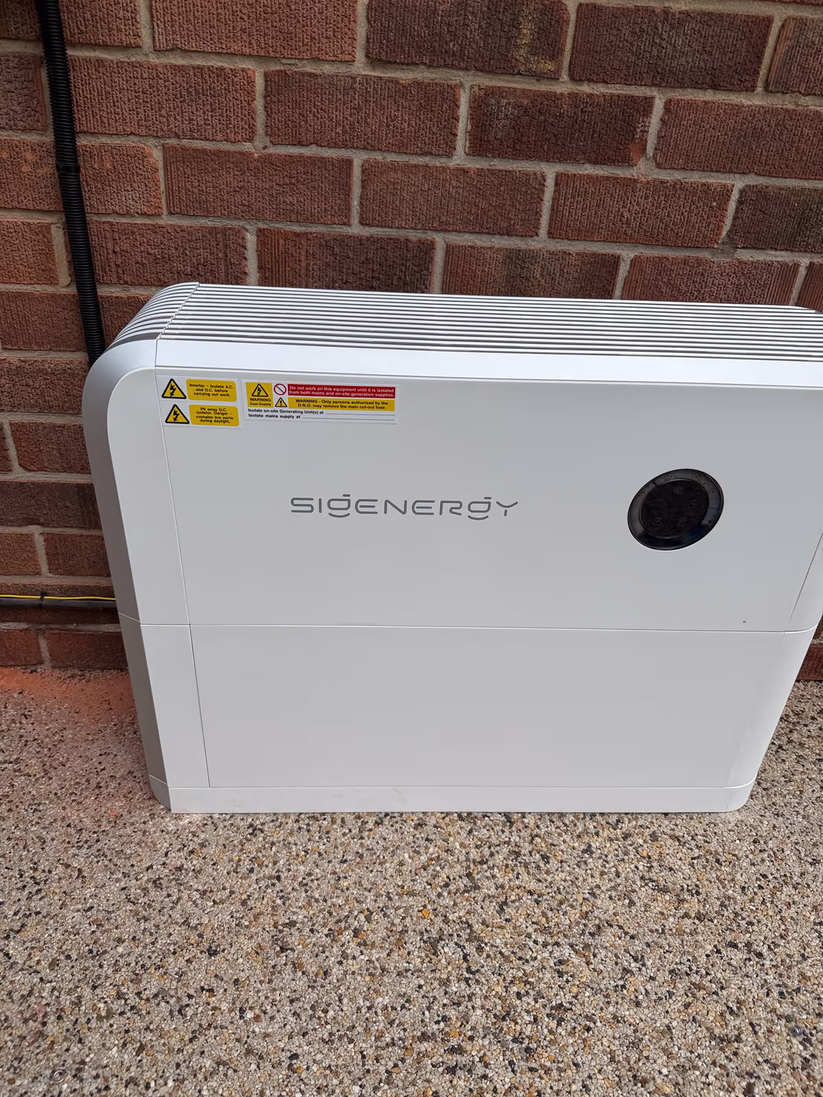 Sigenergy home battery installed against a brick wall