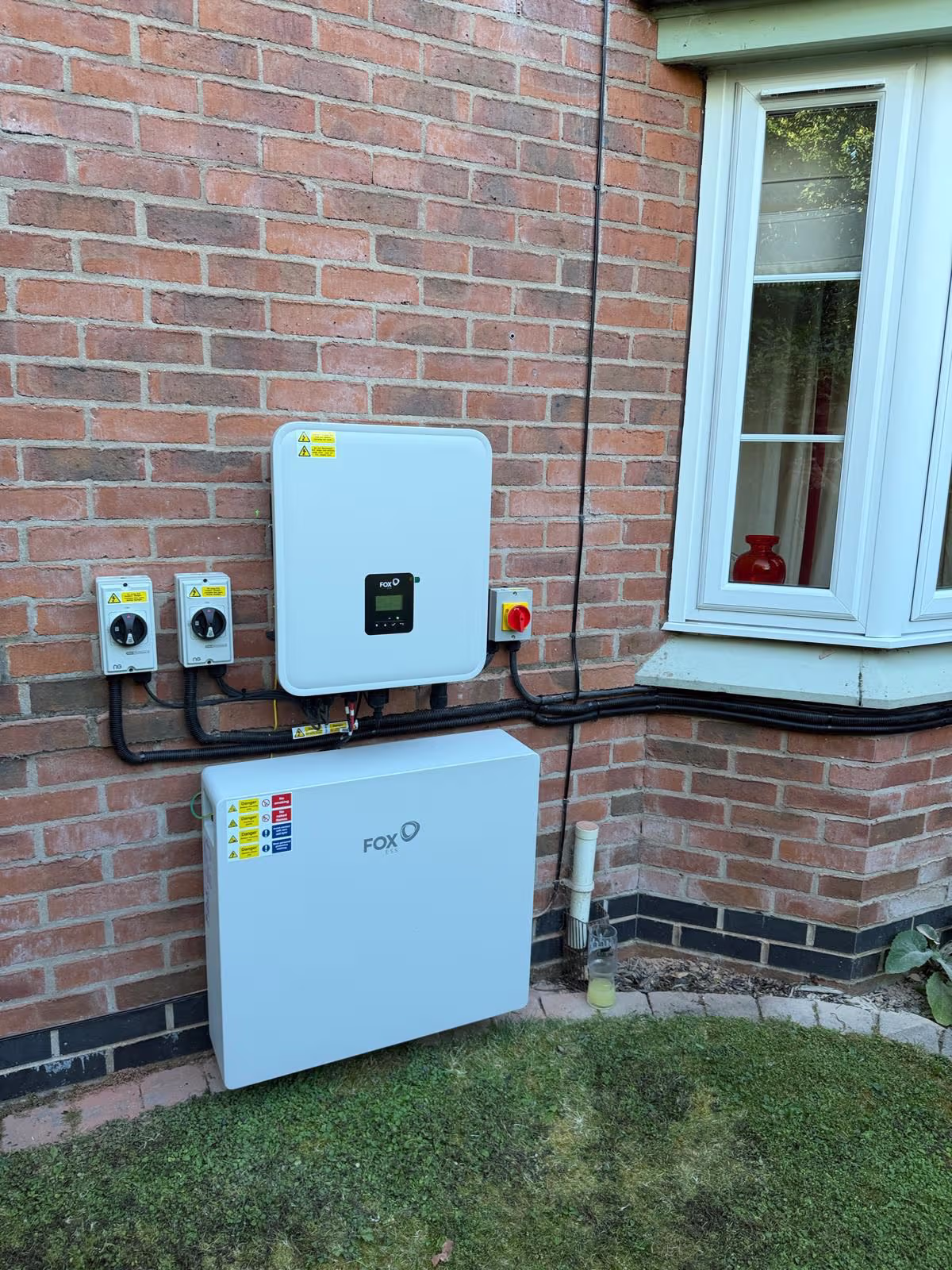 Fox ESS inverter and battery storage installed neatly on a house wall by Renewable Leeds